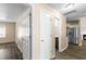 Bright hallway with wood flooring leads to stainless steel refrigerator and rooms at 1081 Singleton Valley Cir, Norcross, GA 30093