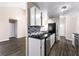 Well-lit kitchen with black countertops, stainless steel appliances, white cabinetry, and stylish backsplash tiles at 1081 Singleton Valley Cir, Norcross, GA 30093