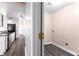 Convenient laundry room adjacent to the kitchen with neutral walls and modern flooring at 1081 Singleton Valley Cir, Norcross, GA 30093