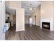 Inviting living room featuring vaulted ceilings, wood-look floors, a cozy fireplace, and seamless flow to the kitchen at 1081 Singleton Valley Cir, Norcross, GA 30093