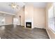 Spacious living room boasts a soaring ceiling, a fireplace with a white mantel, and attractive wood-look floors at 1081 Singleton Valley Cir, Norcross, GA 30093