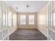 Bright office space with French doors, modern floors, and ample natural light from multiple windows at 1081 Singleton Valley Cir, Norcross, GA 30093