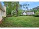Large backyard with mature trees and partial fence line at 1248 Reilly Ln, Clarkston, GA 30021