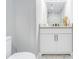 Bathroom vanity with granite counters, white cabinets and mirror at 1248 Reilly Ln, Clarkston, GA 30021