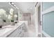 Hall bath with dual sinks, granite countertops, and modern sliding glass door at 1248 Reilly Ln, Clarkston, GA 30021