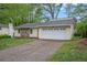 Well-kept single story home with a two car garage, rock facade, and well manicured lawn at 1248 Reilly Ln, Clarkston, GA 30021