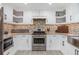 Bright kitchen featuring modern stainless steel appliances, stylish white cabinets, and granite countertops at 1248 Reilly Ln, Clarkston, GA 30021