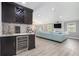 Open concept living room with a built-in bar area featuring a wine cooler and wet bar at 1248 Reilly Ln, Clarkston, GA 30021