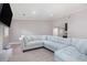 Spacious living room featuring a plush sectional couch, gray walls, and plank flooring at 1248 Reilly Ln, Clarkston, GA 30021