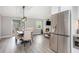 Open floorplan with kitchen, dining area, and living space with gray walls and wood floors at 1248 Reilly Ln, Clarkston, GA 30021