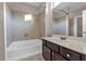 A standard bathroom features a bathtub, shower, sink, and large framed mirror at 2230 Cheshire Bridge Rd # 412, Atlanta, GA 30324