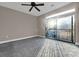 An open bedroom with a ceiling fan and sliding doors lead to an outside balcony at 2230 Cheshire Bridge Rd # 412, Atlanta, GA 30324
