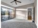 Bright bedroom featuring a fan, neutral walls and soft gray carpet, with balcony access at 2230 Cheshire Bridge Rd # 412, Atlanta, GA 30324