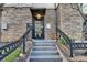 Entrance to unit 400 featuring stone accents, concrete stairs, and black railing at 2230 Cheshire Bridge Rd # 412, Atlanta, GA 30324