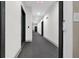 Apartment hallway with gray carpet and dark accent doors at 2230 Cheshire Bridge Rd # 412, Atlanta, GA 30324