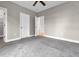 Spacious bedroom with neutral walls, carpet, ceiling fan and access to the walk-in closet at 2230 Cheshire Bridge Rd # 412, Atlanta, GA 30324