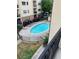 An above view of a community pool with lounge chairs around a fenced area at 2230 Cheshire Bridge Rd # 412, Atlanta, GA 30324