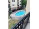 An above view of a community pool with lounge chairs around a fenced area at 2230 Cheshire Bridge Rd # 412, Atlanta, GA 30324