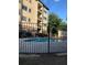 Community pool with chairs, umbrellas, and decorative fence at apartment building at 2230 Cheshire Bridge Rd # 412, Atlanta, GA 30324