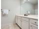 Bright bathroom featuring white cabinets, marble countertops, and a large mirror at 245 Fender Walk, Marietta, GA 30060
