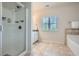 Bright bathroom with a glass-enclosed shower, soaking tub, and tile flooring at 245 Fender Walk, Marietta, GA 30060