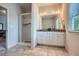 Modern bathroom featuring double vanity sinks, a glass shower, and updated tile flooring at 245 Fender Walk, Marietta, GA 30060