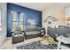 Cozy Bedroom with a modern blue accent wall, crib, glider, and stylish décor at 245 Fender Walk, Marietta, GA 30060