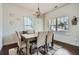 Elegant dining room with chandelier, modern decor, and hardwood floors with lots of light at 245 Fender Walk, Marietta, GA 30060