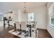 Cozy dining area featuring hardwood floors, a chandelier, and stylish furniture, near kitchen at 245 Fender Walk, Marietta, GA 30060