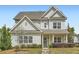 Charming two-story home with light siding, well-manicured landscaping, and welcoming front entrance at 245 Fender Walk, Marietta, GA 30060