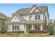 Charming two-story home with light siding, well-manicured landscaping, and inviting front porch at 245 Fender Walk, Marietta, GA 30060