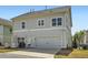 Charming two-story home with a gray exterior, two-car garage, and well-maintained lawn at 245 Fender Walk, Marietta, GA 30060