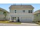 Attractive two-story townhome with a two-car garage and a manicured lawn, enhancing curb appeal at 245 Fender Walk, Marietta, GA 30060