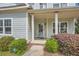 Welcoming front porch with classic columns, neatly trimmed bushes and a well maintained entrance at 245 Fender Walk, Marietta, GA 30060