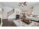 Open-concept living area with hardwood floors, modern decor, connecting kitchen and staircase access at 245 Fender Walk, Marietta, GA 30060