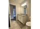 Elegant bathroom features granite countertop, white cabinets, and tile flooring at 80 Hawthorn Ln, Covington, GA 30014