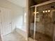 Bright bathroom featuring a soaking tub and tiled shower with glass door at 80 Hawthorn Ln, Covington, GA 30014
