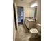 Stylish bathroom with granite countertop, white cabinets, and tile flooring at 80 Hawthorn Ln, Covington, GA 30014