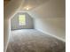 Large bonus room with plush carpet and a window, perfect for versatile use at 80 Hawthorn Ln, Covington, GA 30014