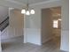 Dining room with hardwood floors, crown molding, and modern chandelier lighting at 80 Hawthorn Ln, Covington, GA 30014