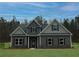Beautiful two-story home with dark siding, black shutters, covered entry, and a manicured lawn at 80 Hawthorn Ln, Covington, GA 30014