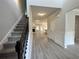 Open foyer with hardwood floors, stairs, and views into the living room and kitchen at 80 Hawthorn Ln, Covington, GA 30014