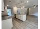 Kitchen island with granite countertop and sink with a view to the living room at 80 Hawthorn Ln, Covington, GA 30014