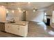 Open concept kitchen features granite countertops, island with sink, and stainless dishwasher at 80 Hawthorn Ln, Covington, GA 30014