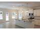 Bright kitchen boasts white cabinets, granite countertops, stainless appliances, and island with sink at 80 Hawthorn Ln, Covington, GA 30014