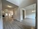 Open-concept living room and dining room with hardwood floors and neutral paint at 80 Hawthorn Ln, Covington, GA 30014