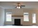 Cozy living room features a white shiplap fireplace, hardwood floors, and natural light at 80 Hawthorn Ln, Covington, GA 30014