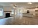 Open-concept living space with a kitchen, fireplace, and natural light at 80 Hawthorn Ln, Covington, GA 30014