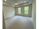 Spacious bedroom with a neutral color palette, plush carpeting, and natural lighting at 1059 Dryden Ln # 11, Atlanta, GA 30319