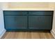 Stylish blue painted cabinets featuring brushed brass hardware with wood flooring at 1059 Dryden Ln # 11, Atlanta, GA 30319